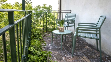 Balcony of a room with chairs and table