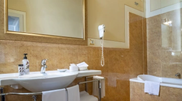 Bathroom with bathtub and hairdryer