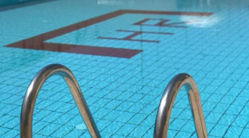 Swimming pool with ladder