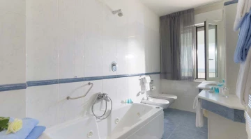 Private bathroom with tub and shower