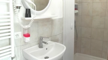 Bathroom with hairdryer and shower cubicle