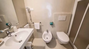 En-suite bathroom with hairdryer and shower cubicle