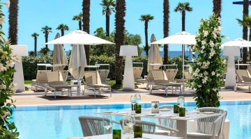 Tables et solarium au bord de la piscine