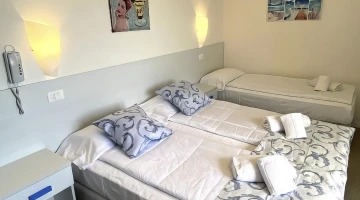 Dreibettzimmer mit Handtüchern