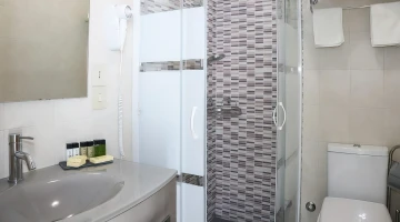 Bathroom with shower cubicle in one room