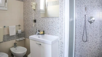 Bathroom with shower cubicle and hairdryer