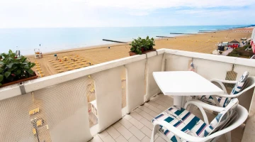 Sea view balcony with table and chairs
