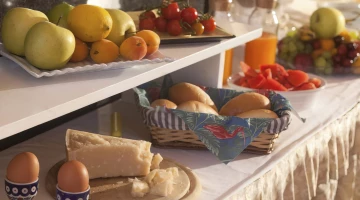 Breakfast buffet with cheeses, eggs and fruit