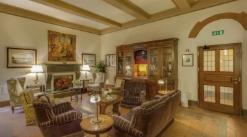 Common room with armchairs, sofas and bookcase