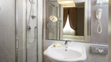 Bathroom with shower cubicle, hairdryer and magnifying mirror