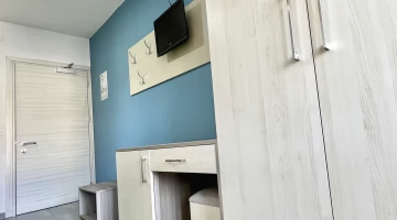 Room with desk and TV