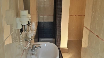 Bathroom with hairdryer and shower