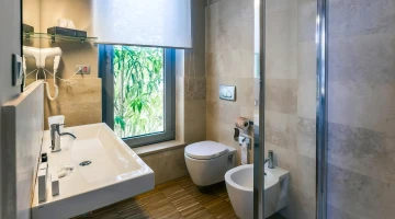 Private bathroom with wall-mounted hairdryer