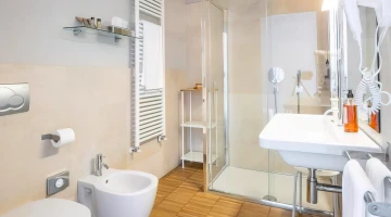 Private bathroom with shower cubicle and wall-mounted hairdryer