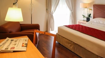 Double bedroom with balcony and armchair