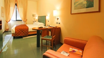 Double bedroom with armchair and desk
