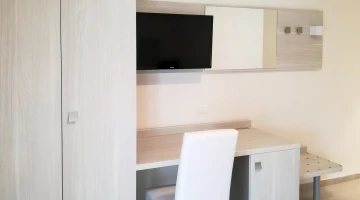 Zimmer mit TV und Schreibtisch