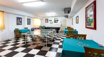 Room with ping pong and billiard tables