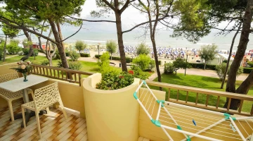 Private balcony with drying rack, table and chairs