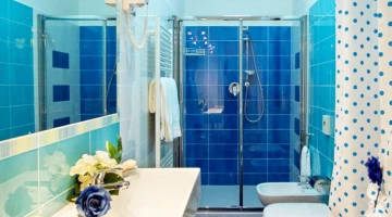 Eigenes Badezimmer mit wandmontiertem Haartrockner und Duschkabine