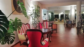 Common room with tables, armchairs and sofas