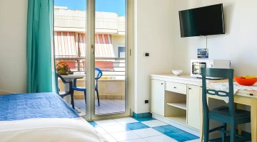 Room with a balcony and TV