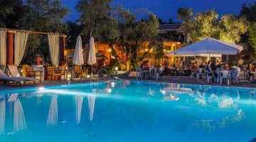 Swimming pool surrounded by tables and chairs