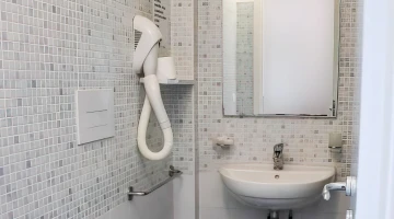 Private bathroom with wall-mounted hairdryer