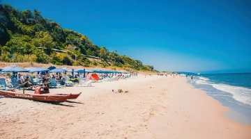Beach with reserved deckchairs and umbrellas