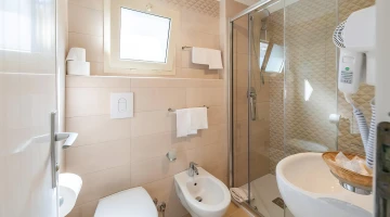 Bathroom with hairdryer and shower cubicle