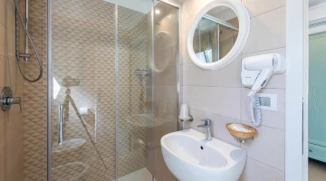 Bathroom with shower cubicle and hairdryer