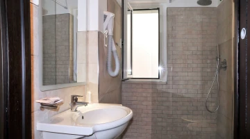 Bathroom with shower cubicle and hairdryer