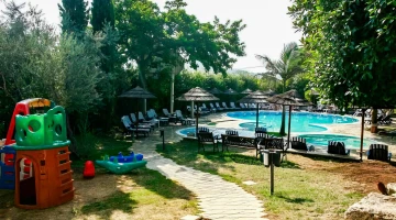 Garden with swimming pool and children&#39;s games