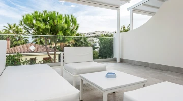 Private balcony with table and sofas