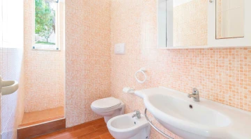 Bathroom with shower cubicle in two-room apartment