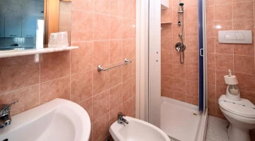 Bathroom with shower cubicle in two-room apartment