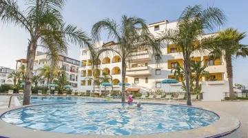 Outdoor swimming pool with palm trees