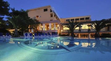 Hotel in the evening with illuminated swimming pool