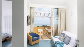 Room with armchair and balcony