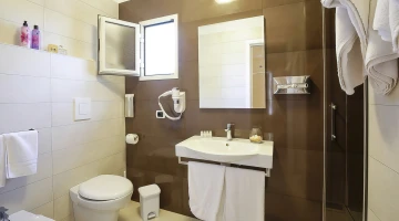 Private bathroom with shower cubicle and wall-mounted hairdryer