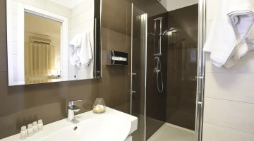 Private bathroom with shower cubicle and courtesy set