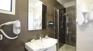 Private bathroom with hairdryer and shower cubicle
