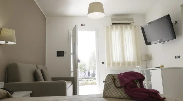Deluxe double room with sofa and TV