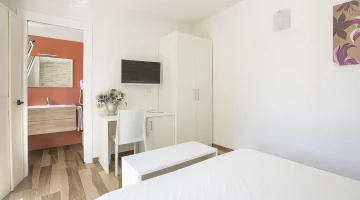 Room with a TV and bathroom