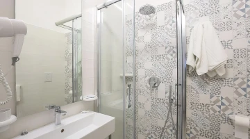 Bathroom detail with hairdryer and shower cubicle