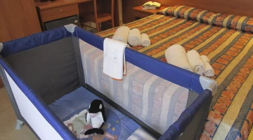 Double bed and cot in Standard Room