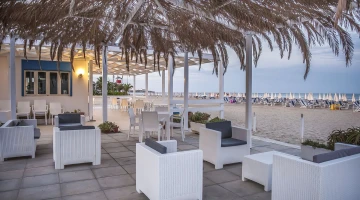 Tables and armchairs on the beach