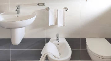 Private bathroom with wall-mounted hairdryer