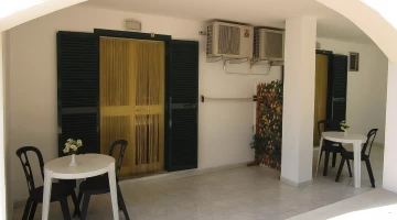 Private patio with tables and chairs