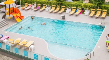 Swimming pool with solarium and slide